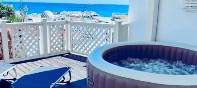 Beach front Villa with hot tub, just steps from the sea in Στεγνά